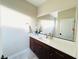 Modern bathroom with a single vanity and large mirror at 210 Abbey Hill St, Henderson, NV 89012