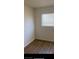 Simple bedroom with vinyl plank flooring and window at 2516 Ellis St, North Las Vegas, NV 89030