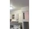 White kitchen cabinets with range and overhead cabinets at 2517 Cedar Ave, Las Vegas, NV 89101