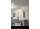 White kitchen cabinets with range and overhead cabinets at 2517 Cedar Ave, Las Vegas, NV 89101