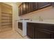 Laundry room with washer, dryer, shelving, and utility sink at 2811 Shadows Edge Ct, Henderson, NV 89052