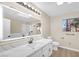Bright bathroom with white vanity, modern fixtures, an LED mirror and a large window for natural light at 2851 S Valley View Blvd # 1195, Las Vegas, NV 89102