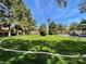 A lush green lawn with picnic tables and benches in front of a row of tan houses at 2851 S Valley View Blvd # 1195, Las Vegas, NV 89102