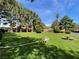 A well maintained front yard with a green lawn, trees, benches, and tan houses at 2851 S Valley View Blvd # 1195, Las Vegas, NV 89102