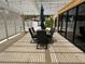 Outdoor dining area on a covered patio featuring a stone floor, an umbrella, and black furniture at 2851 S Valley View Blvd # 1195, Las Vegas, NV 89102