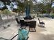Outdoor dining area on a patio with a stone bench, an umbrella, and a decorative chair at 2851 S Valley View Blvd # 1195, Las Vegas, NV 89102