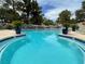 A community swimming pool surrounded by lawn chairs and potted plants at 2851 S Valley View Blvd # 1195, Las Vegas, NV 89102
