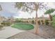 Landscaped backyard with artificial turf and decorative rock at 2951 Maffie St, Henderson, NV 89052