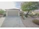 House exterior with attached garage and mature tree at 2951 Maffie St, Henderson, NV 89052