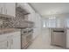Kitchen with white cabinets, granite counters, and a stone backsplash at 2951 Maffie St, Henderson, NV 89052