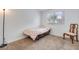 Small bedroom with a single bed, window, and chair at 2983 Juniper Hills Blvd # 102, Las Vegas, NV 89142