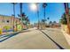 View of the community entrance with secured gate and desert landscaping at 2983 Juniper Hills Blvd # 102, Las Vegas, NV 89142