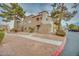 Exterior shot of condo building with well-maintained landscaping at 2983 Juniper Hills Blvd # 102, Las Vegas, NV 89142