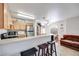 Kitchen features light wood cabinets, stainless steel appliances, and breakfast bar at 2983 Juniper Hills Blvd # 102, Las Vegas, NV 89142