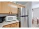 View of kitchen appliances, including microwave and refrigerator at 2983 Juniper Hills Blvd # 102, Las Vegas, NV 89142