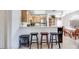 Kitchen boasts light wood cabinets, stainless steel appliances, and breakfast bar at 2983 Juniper Hills Blvd # 102, Las Vegas, NV 89142