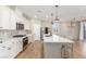 Modern kitchen with white cabinets and a large island at 3032 Gravino Ave, Henderson, NV 89044