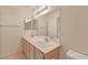 Bathroom features a dual sink vanity, a large mirror, and a toilet at 3425 E Russell Rd # 227, Las Vegas, NV 89120