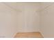 Walk-in closet with modern shelving and light hardwood flooring for organized storage at 3425 E Russell Rd # 227, Las Vegas, NV 89120