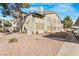 Exterior view showcasing a tan two-story residential building with landscaping and parking at 3425 E Russell Rd # 227, Las Vegas, NV 89120