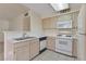 Bright kitchen with white appliances and light wood cabinets at 3425 E Russell Rd # 227, Las Vegas, NV 89120