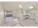 Bright kitchen and dining area with white appliances, tile floors and sliding glass door at 3425 E Russell Rd # 227, Las Vegas, NV 89120