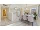 Bright kitchen and dining area with white appliances, tile floors and tastefully decorated dining area at 3425 E Russell Rd # 227, Las Vegas, NV 89120