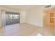 Bright living room featuring new floors and sliding glass door to the balcony at 3425 E Russell Rd # 227, Las Vegas, NV 89120