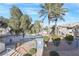 View of a community pool and mature landscaping. with surrounding two-story buildings at 3425 E Russell Rd # 227, Las Vegas, NV 89120