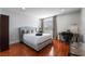Bedroom with a queen bed, desk, and wood floors at 3585 Arville St # 402C, Las Vegas, NV 89103