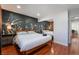 Spacious bedroom with leafy wall mural and wood bed frame at 3585 Arville St # 402C, Las Vegas, NV 89103