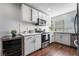 Updated kitchen with white cabinets and wood floors at 3585 Arville St # 402C, Las Vegas, NV 89103