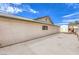 Home exterior featuring a concrete driveway, stucco walls and a view of the backyard shed at 4720 E Wyoming Ave, Las Vegas, NV 89104