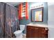 Bathroom with a vanity, toilet, framed mirror, and a shower with decorative curtain at 4726 Beaconsfield St, Las Vegas, NV 89147