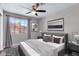 Cozy bedroom with a ceiling fan, neutral walls, and a bright window view at 4726 Beaconsfield St, Las Vegas, NV 89147