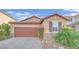 Single-story home with brown garage door, stone accents, and landscaped yard at 5344 Bocopa St, Las Vegas, NV 89148