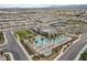 An aerial view showcases the stunning community clubhouse with pools, and palm trees, surrounded by residences at 6524 Summershade St, North Las Vegas, NV 89086