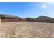 This large, undeveloped backyard is enclosed by a block wall and offers blue sky views at 6524 Summershade St, North Las Vegas, NV 89086