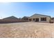 Undeveloped backyard with block wall and views of neighborhood homes under clear blue sky at 6524 Summershade St, North Las Vegas, NV 89086