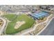 An aerial view of a neighborhood park, with pickle ball courts and fenced dog park at 6524 Summershade St, North Las Vegas, NV 89086