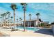 Stunning community pool and clubhouse surrounded by palm trees, lounge seating, and a bright blue sky at 6524 Summershade St, North Las Vegas, NV 89086