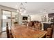 Open dining room with wooden table connected to living spaces, offering plenty of seating and natural light at 6524 Summershade St, North Las Vegas, NV 89086