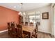 Comfortable dining room with wooden table, decorative chairs, a grandfather clock, and natural light at 6524 Summershade St, North Las Vegas, NV 89086