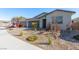Attractive single-Gathering home with a gray two-car garage, a neutral facade, and desert landscaping at 6524 Summershade St, North Las Vegas, NV 89086