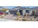 Charming single-story home features desert landscaping, a two-car garage, and a brick driveway at 6524 Summershade St, North Las Vegas, NV 89086
