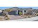 Charming single-story home features desert landscaping, a two-car garage, and a brick driveway at 6524 Summershade St, North Las Vegas, NV 89086