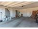 Uncluttered garage features concrete floors, storage shelves, with room for parking at 6524 Summershade St, North Las Vegas, NV 89086