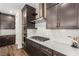 Close up view of kitchen with stainless steel appliances, white countertops, and dark wood cabinetry at 6524 Summershade St, North Las Vegas, NV 89086