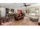 Open-concept living area with kitchen and dining views, showcasing wood floors and comfortable seating at 6524 Summershade St, North Las Vegas, NV 89086