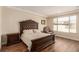 This main bedroom showcases a tray ceiling and a large window for natural light at 6524 Summershade St, North Las Vegas, NV 89086